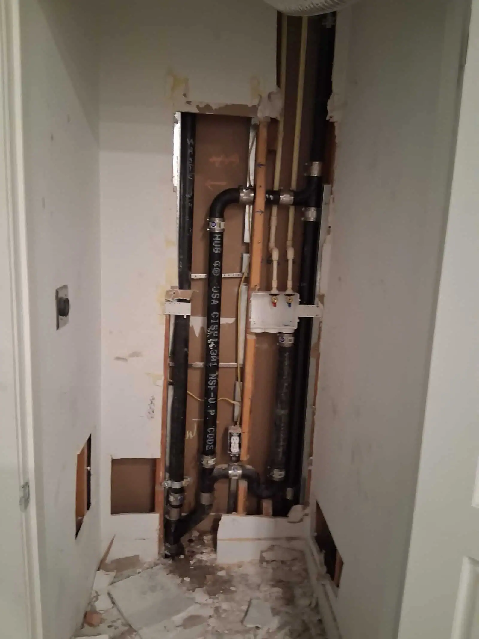 Plumbing pipes installed inside wall cavity for residential plumbing system.