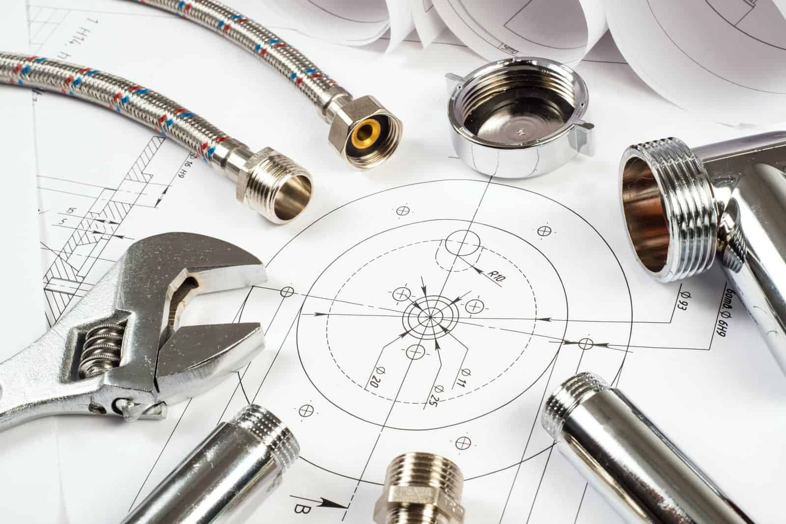 Flexible metal hoses with fittings and plumbing tools on technical blueprints.